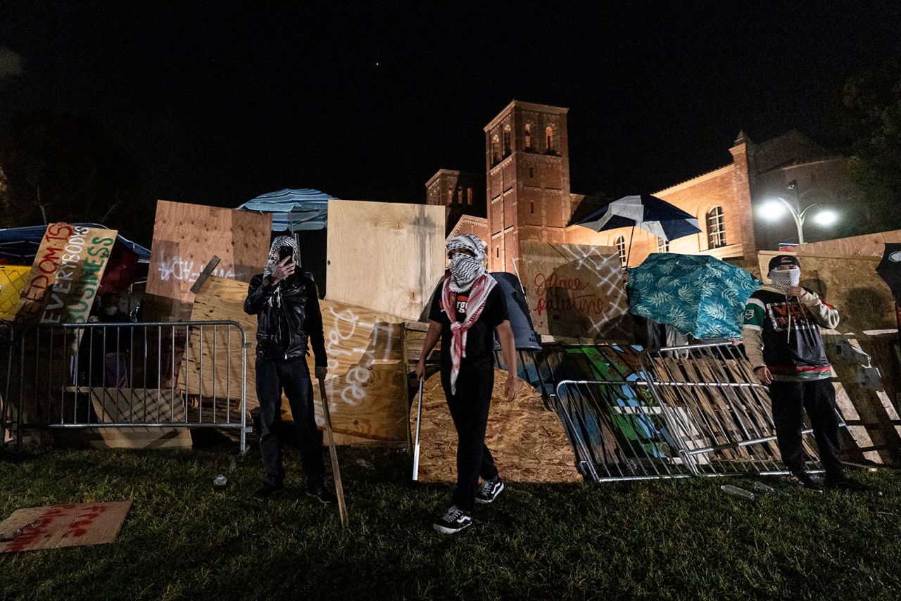 Pro-Palestinian demonstrators rebuild a barricade around an encampment on the campus of the University of California, Los Angeles (UCLA) on Wednesday, May 1. Before police were deployed to campus, pro-Palestinian protesters and Israel supporters were clashing at the school, according to multiple reports. 