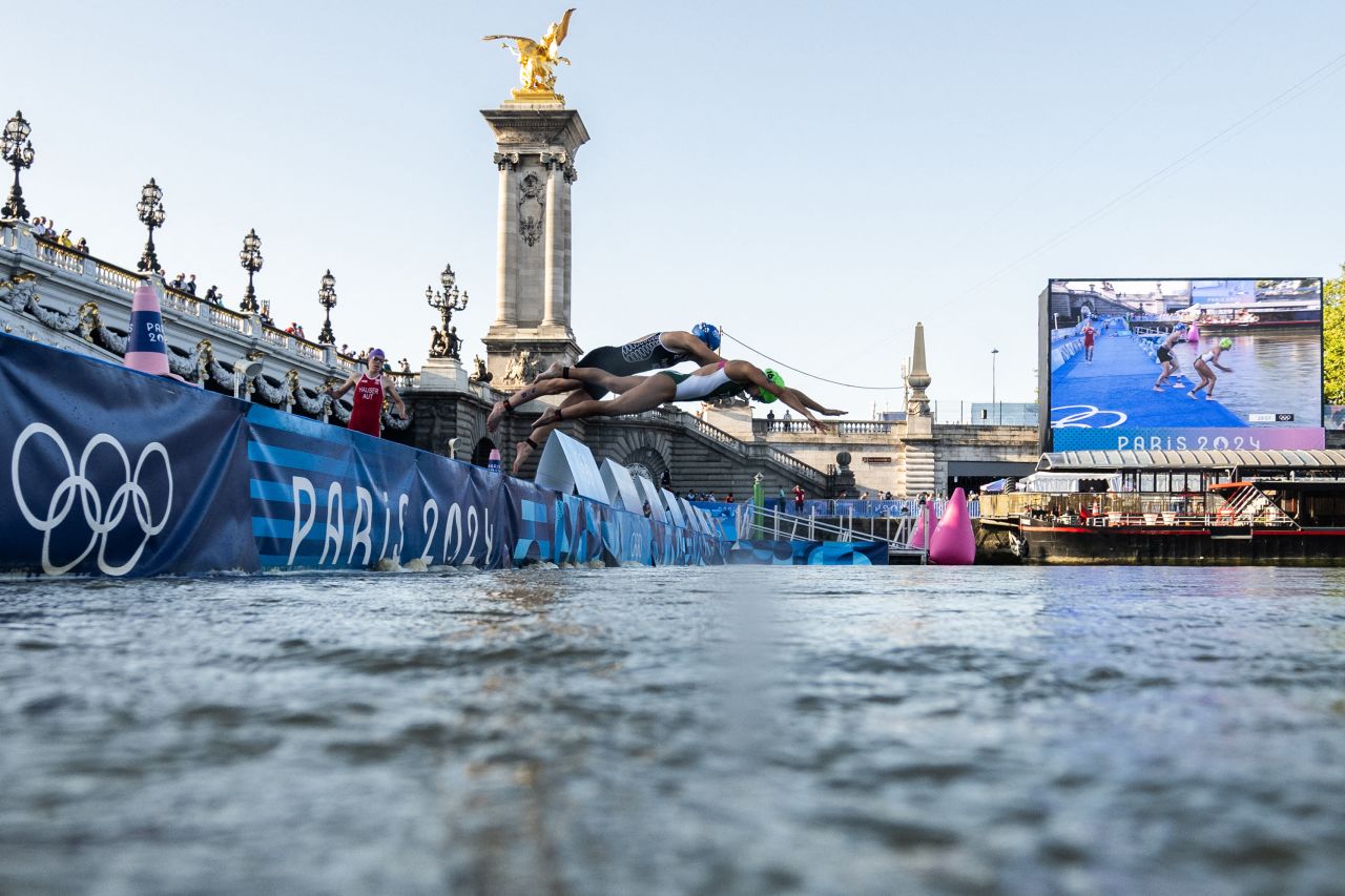 Athletes jump into the Seine during the mixed relay triathlon on August 5.