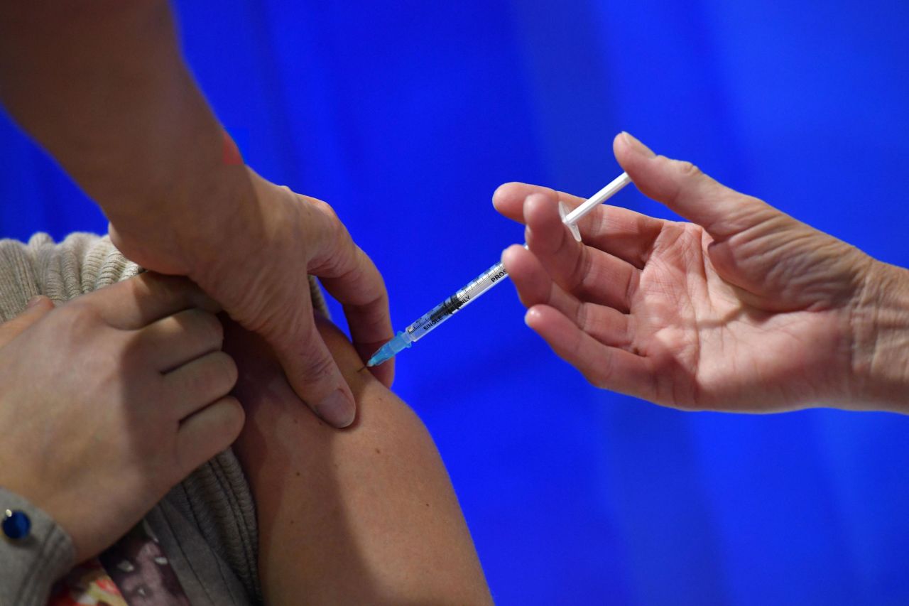 A woman receives an injection of the Pfizer-BioNTech Covid-19 vaccine at a health center on December 8 in Cardiff, UK. 