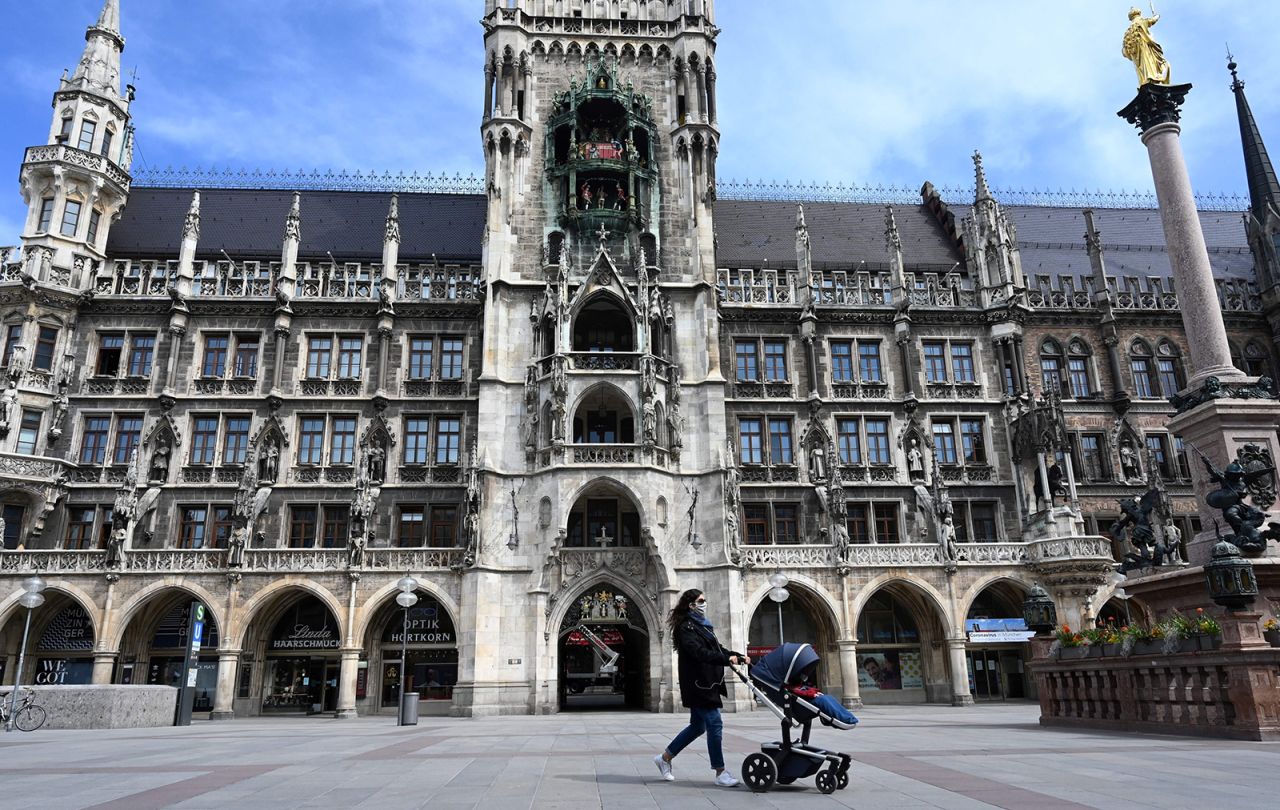 A woman pushing a stroller walks at the empty Marienplatz in Munich on April 21.