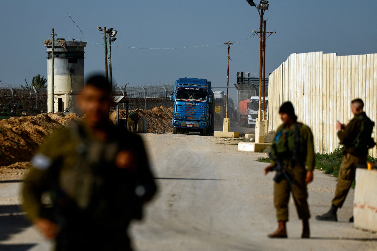 Aid trucks enter from Egypt en route to Gaza, seen from the Kerem Shalom crossing in Israel on Friday.