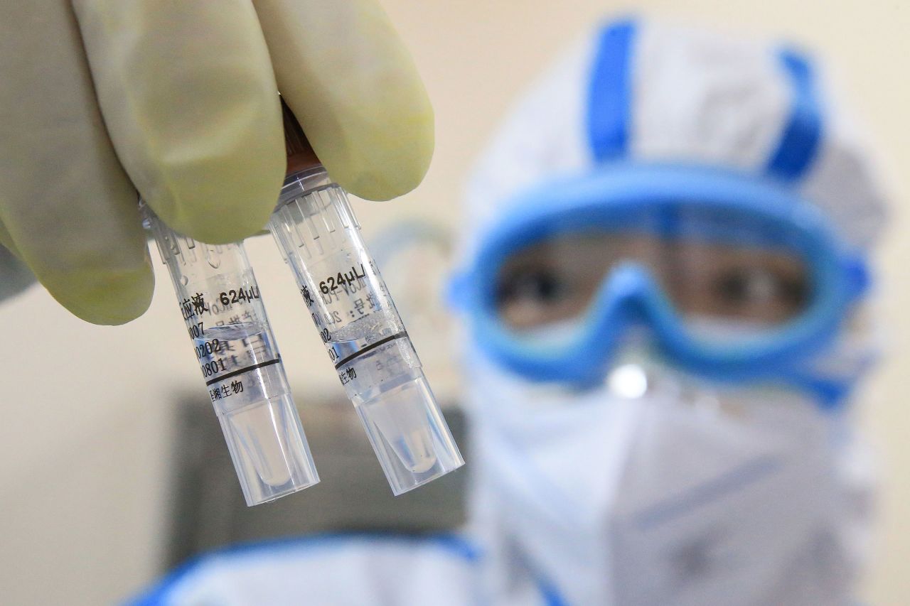 A laboratory technician holds virus samples at a laboratory in Hengyang in China's central Henan province, on February 19.