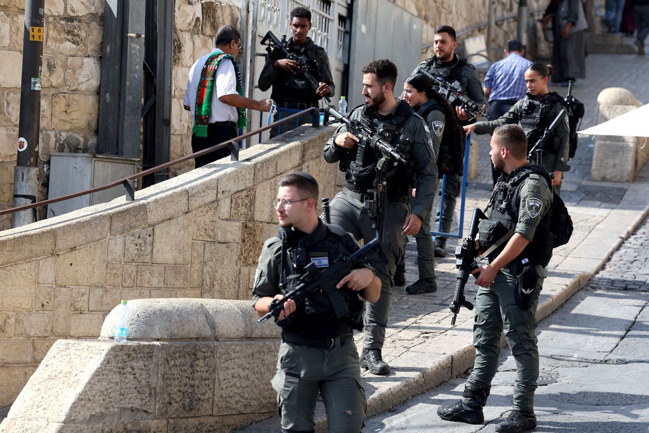 Israeli border police watch as Muslim worshippers arrive at the Lion's Gate to make their way to the Al-Aqsa mosque compound for noon prayer on October 27.