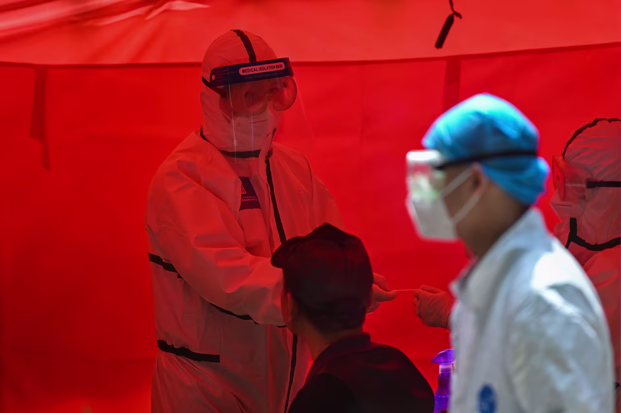 A medical worker prepares to perform a coronavirus test in Wuhan on Tuesday.