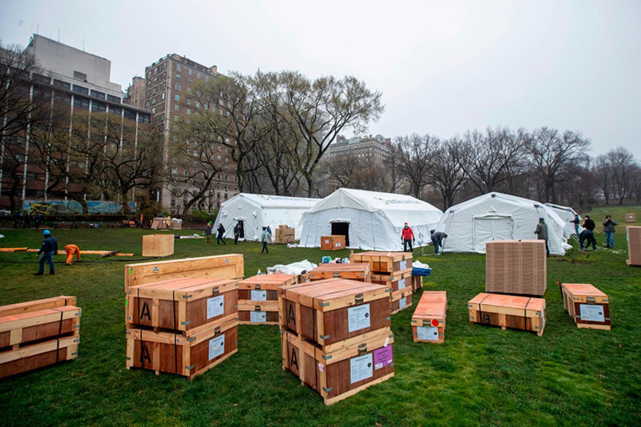 A Samaritan's Purse crew works on building an emergency field hospital equipped with a respiratory unit in New York's Central Park across from the Mount Sinai Hospital, Sunday, March 29. 