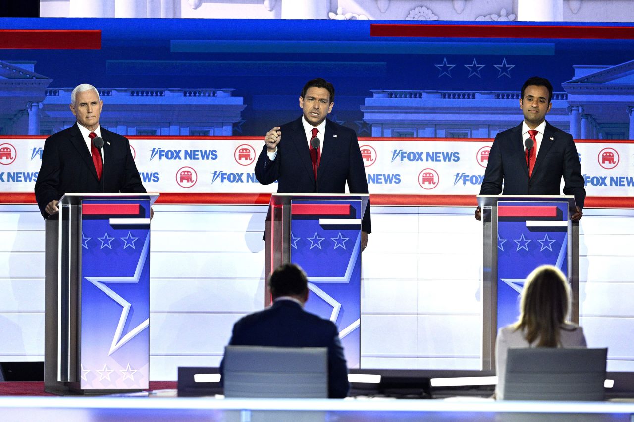 Florida Governor Ron DeSantis speaks, flanked by former US Vice President Mike Pence and entrepreneur and author Vivek Ramaswamy, during the first Republican Presidential primary debate at the Fiserv Forum in Milwaukee on Wednesday.