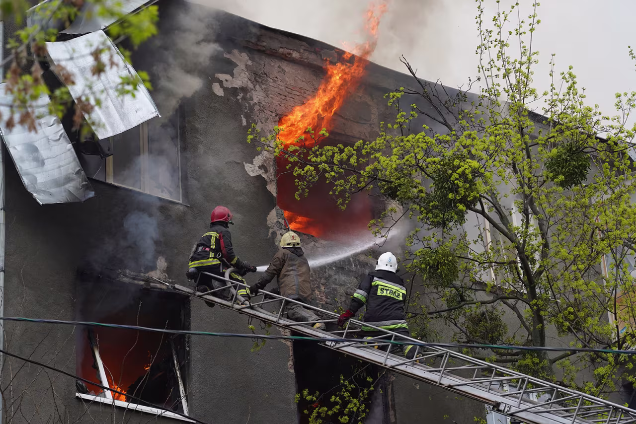 Firefighters work to extinguish fire at an apartments building after a Russian attack in Kharkiv, Ukraine, Sunday, April 17.