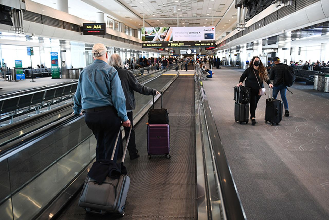 Airline passengers walk to flights in the airport terminal in Denver, Colorado on April 19.