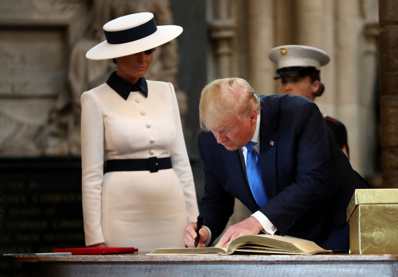 Trump signs the visitors book during the visit to Westminster Abbey with First Lady Melania Trump on Monday in London.