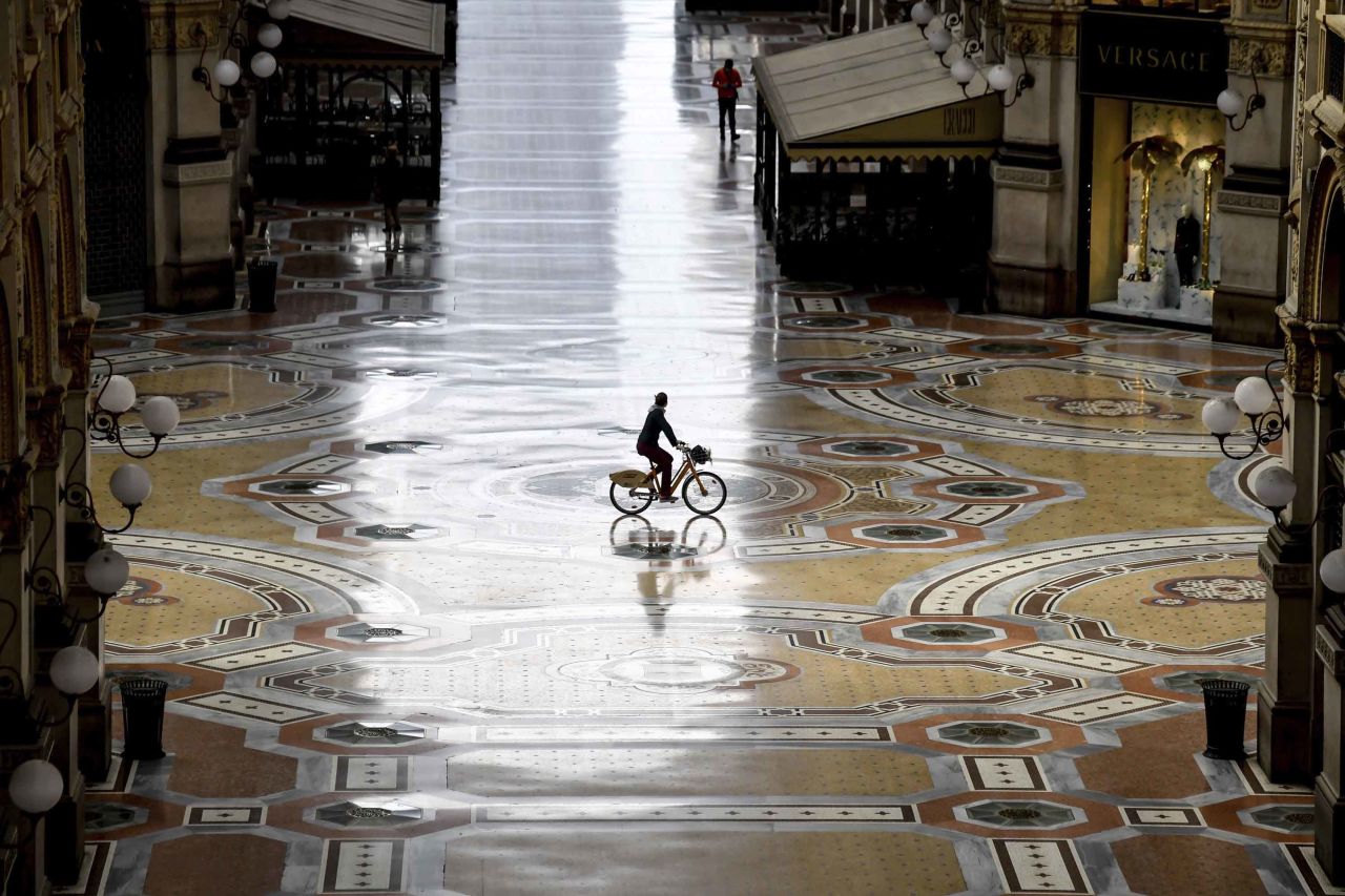 A cyclist rides along an empty Galleria Vittorio Emanuele II shopping arcade during Italy's continued lockdown in Milan on Thursday, April 30.