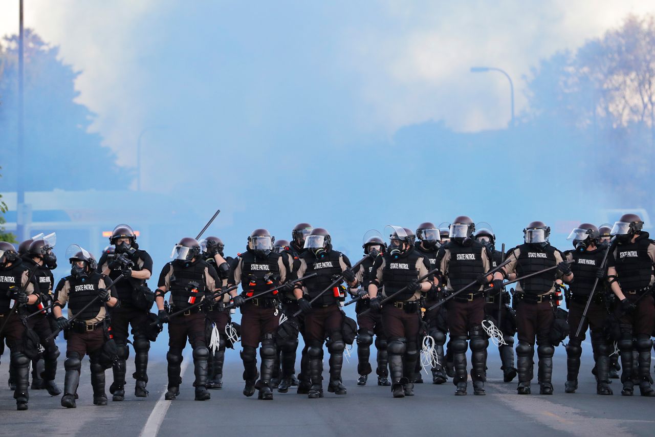 State troopers clear an area after curfew on Saturday, May 30, in Minneapolis.