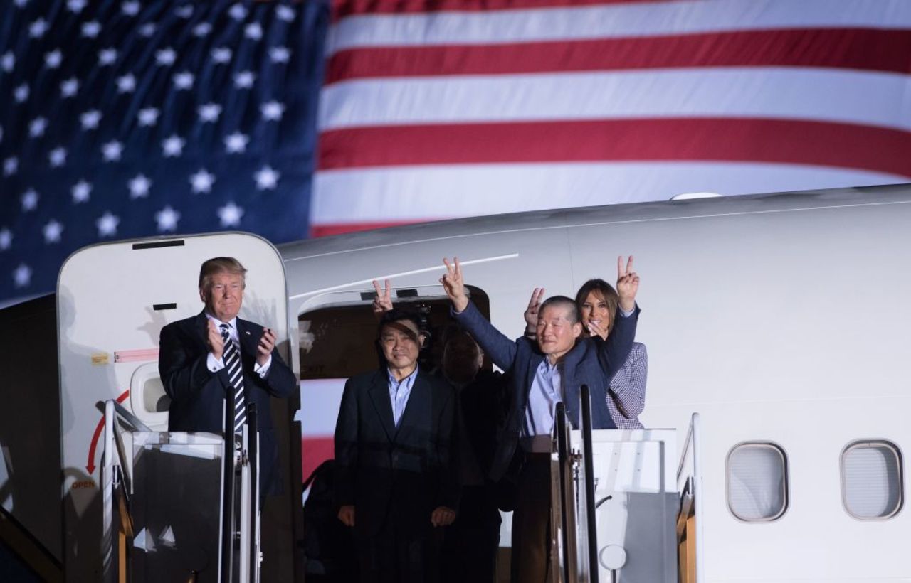 US President Donald Trump (L) applauds as US detainee Kim Dong-chul (2nd R) gestures upon his return with Kim Hak-song (behind) and Tony Kim (2nd L) after they were released by North Korea, at Joint Base Andrews in Maryland on May 10, 2018. 