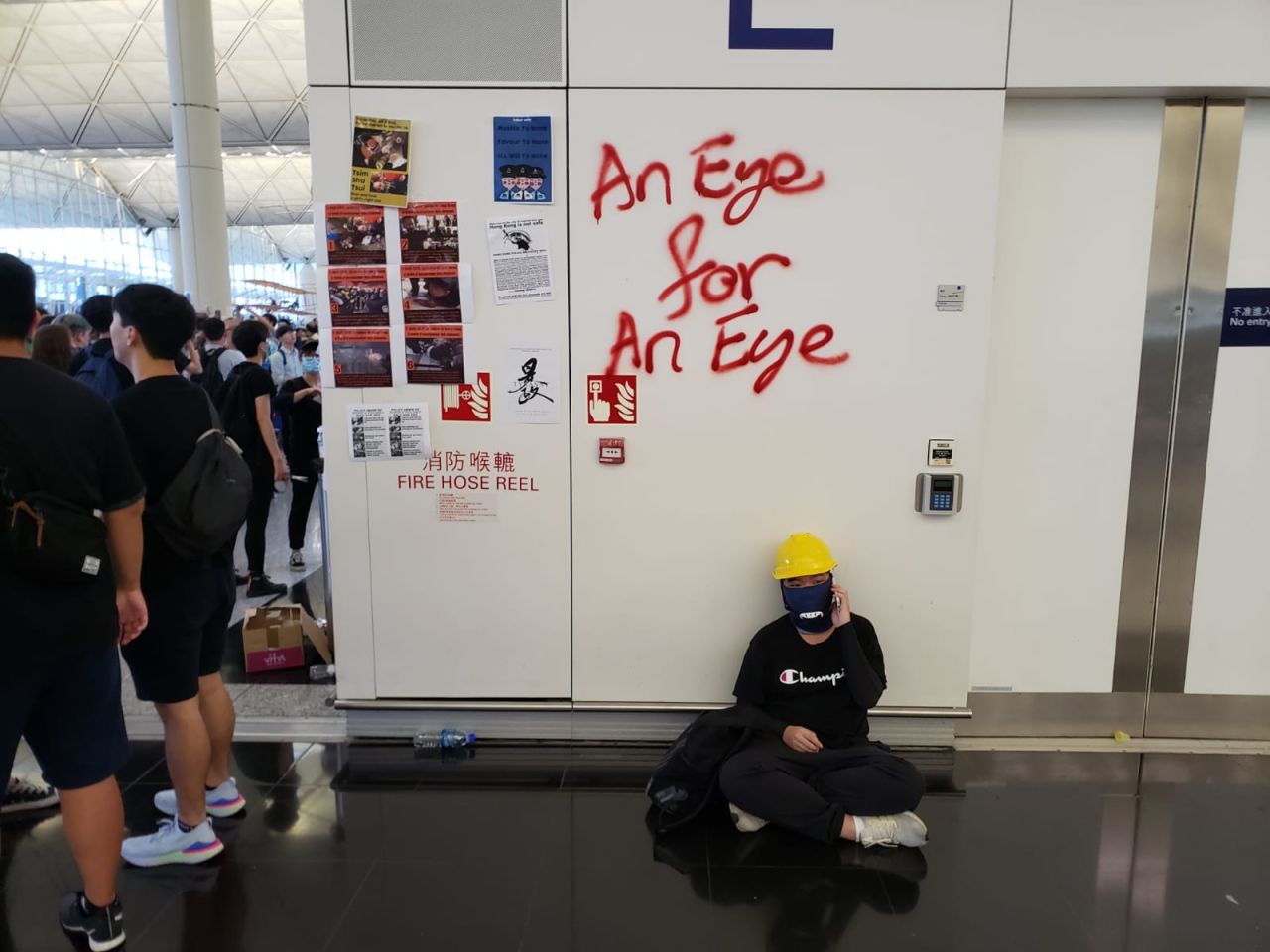 Protesters at the airport have plastered walls with posters and graffiti.  Ben Westcott/CNN