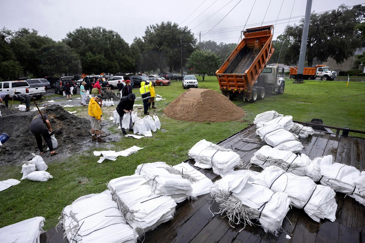 Chatham County employees dump a truck load of sand for residents to use in sandbag as they prepare for Hurricane Debby, in Savannah, Georgia on August 5.