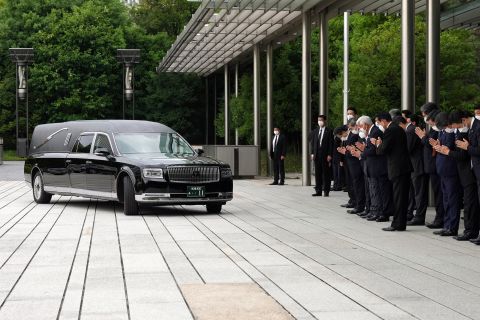 A hearse carrying the body of former Japanese Prime Minister Shinzo Abe, makes a brief visit to the Prime Minister's Office, as Japan's Prime Minister Fumio Kishida, officials and employees offer prayers, in Tokyo, Japan, on July 12.