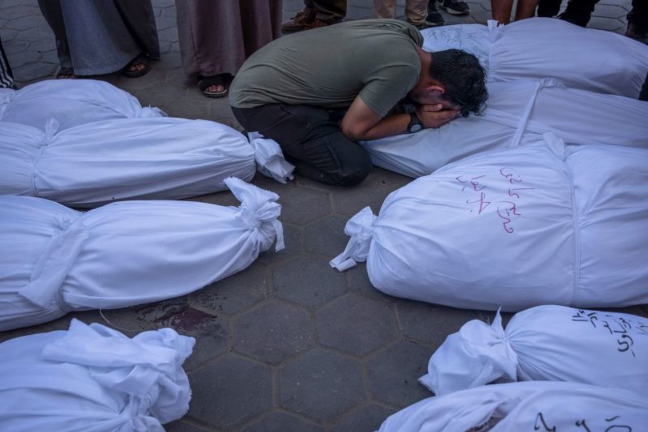 Palestinians mourn relatives killed in the Israeli bombardment of Gaza in front of the morgue in Deir al Balah on October 31. 