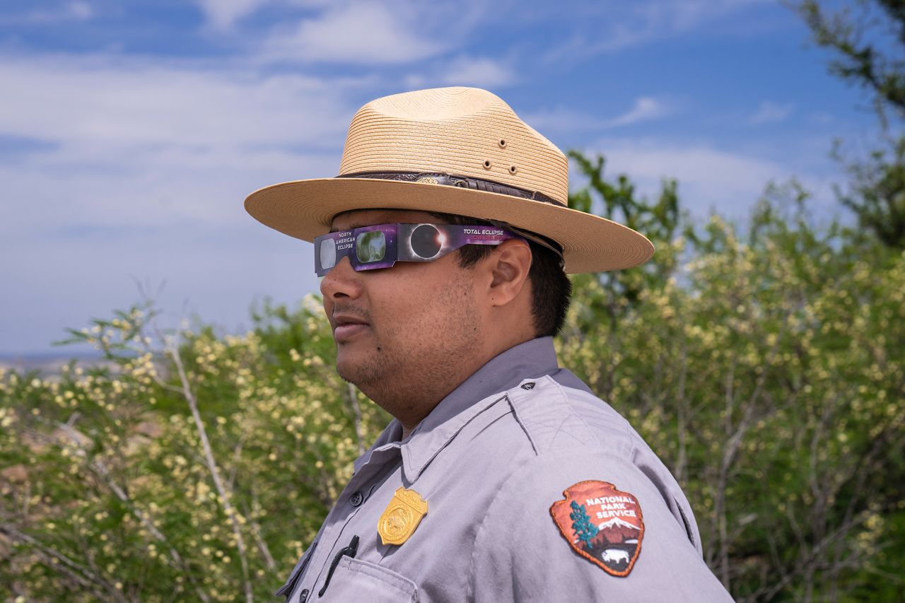 Park ranger Austin Rogers tests out his eclipse glasses Saturday at the Amistad National Recreation Area. Rogers said he has seen four times the amount of visitors that he normally sees at his ranger station.