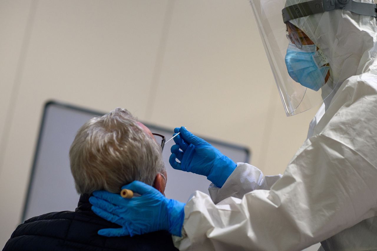 An employee of Magdeburg University Hospital performs an antigen test for the coronavirus on a man in Magdeburg, Germany, on January 12.