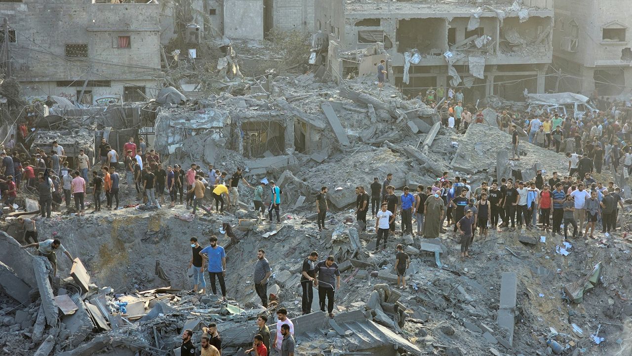 Palestinians search for casualties at the site of a strike in Jabalya Refugee Camp in Gaza on October 31.