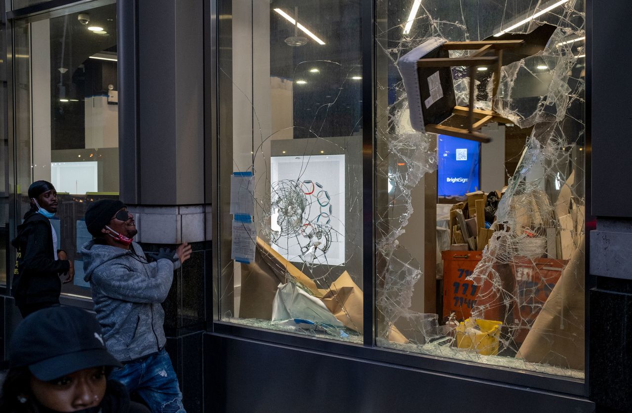 A stool is thrown through a window of a store in the Chelsea neighborhood of New York, on Monday, June 1. 