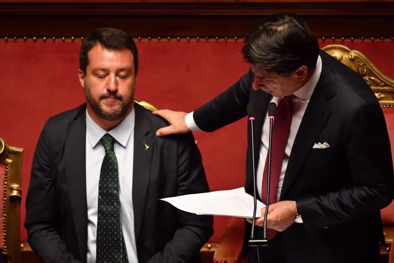 Italian Prime Minister Giuseppe Conte (R) touches Deputy Prime Minister and Interior Minister Matteo Salvini's shoulder as he delivers a speech at the Italian Senate, in Rome, on August 20, 2019, as the country faces a political crisis.