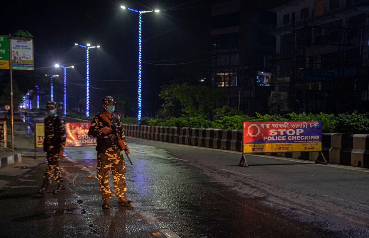 Indian paramilitary personnel stand on a deserted road during a complete lockdown amid growing concerns of coronavirus in Gauhati, India, on Tuesday, March 24.