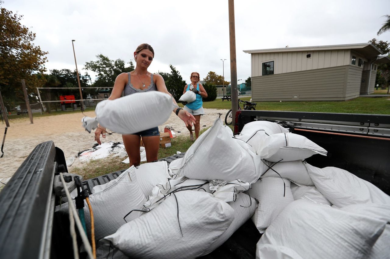 Heather Burdine and Patricia McCoury load sand bags onto a truck on Tybee Island near Savannah, Georgia, on Tuesday.