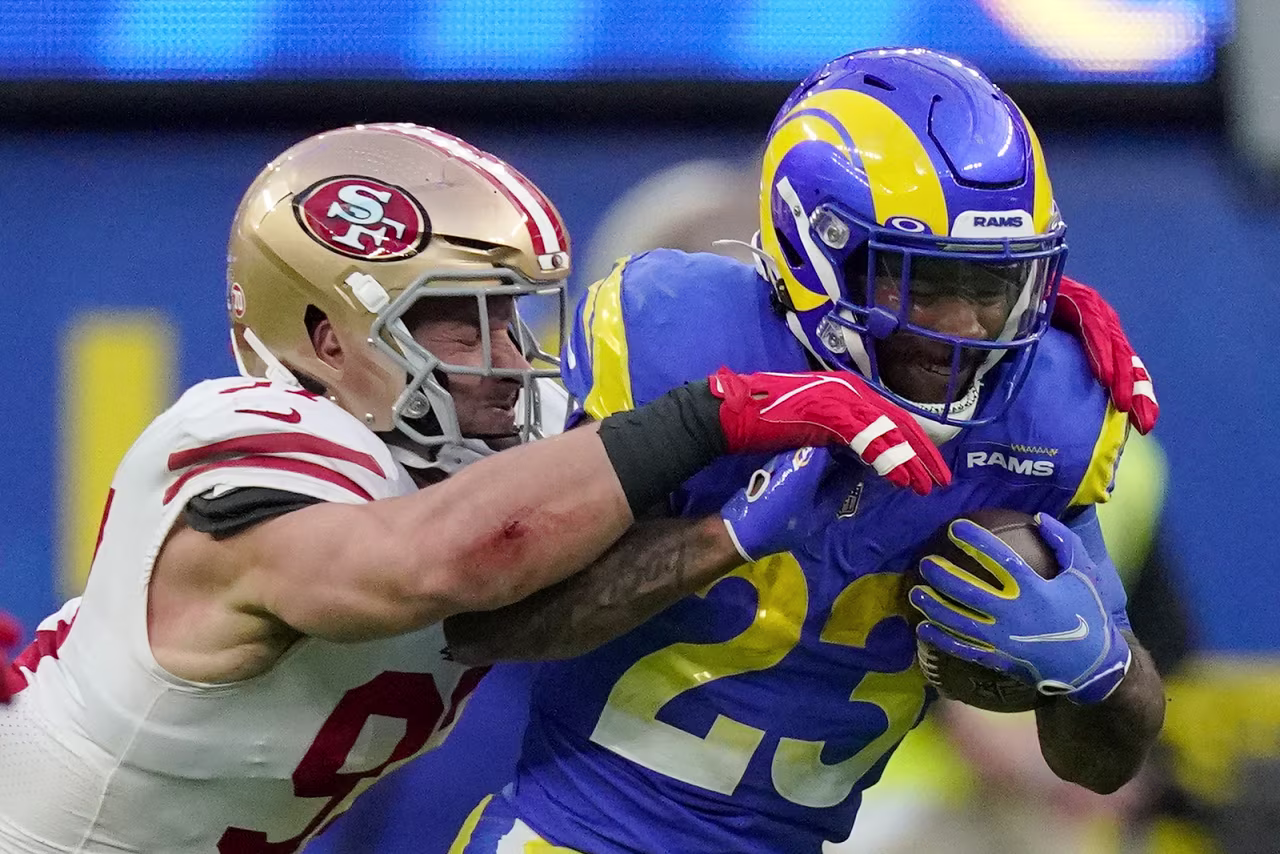 San Francisco 49ers' Nick Bosa, left, stops Los Angeles Rams' Cam Akers during the first half of the NFC Championship NFL football game Sunday, January 30, in Inglewood, California.