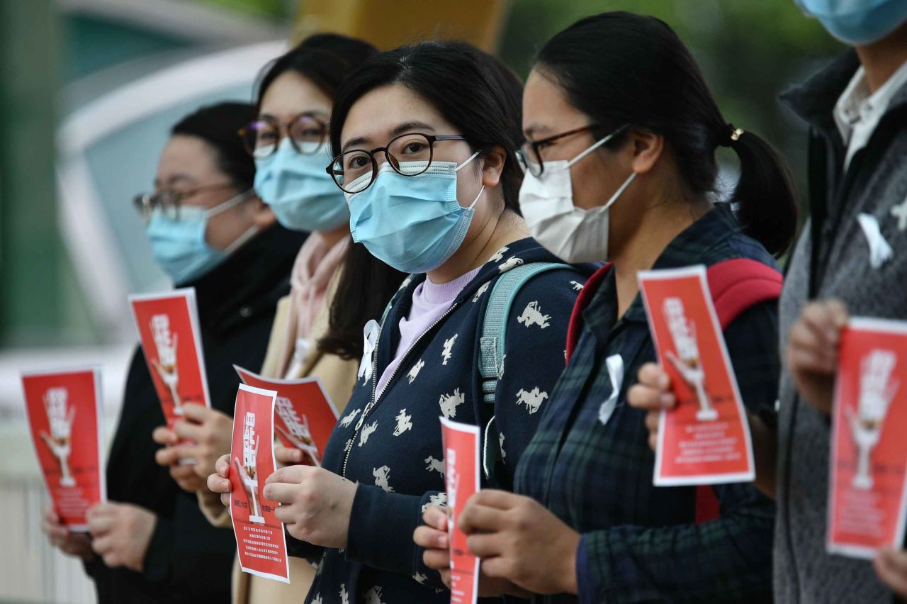 Local medical workers hold a strike near Queen Mary Hospital in Hong Kong on Friday.