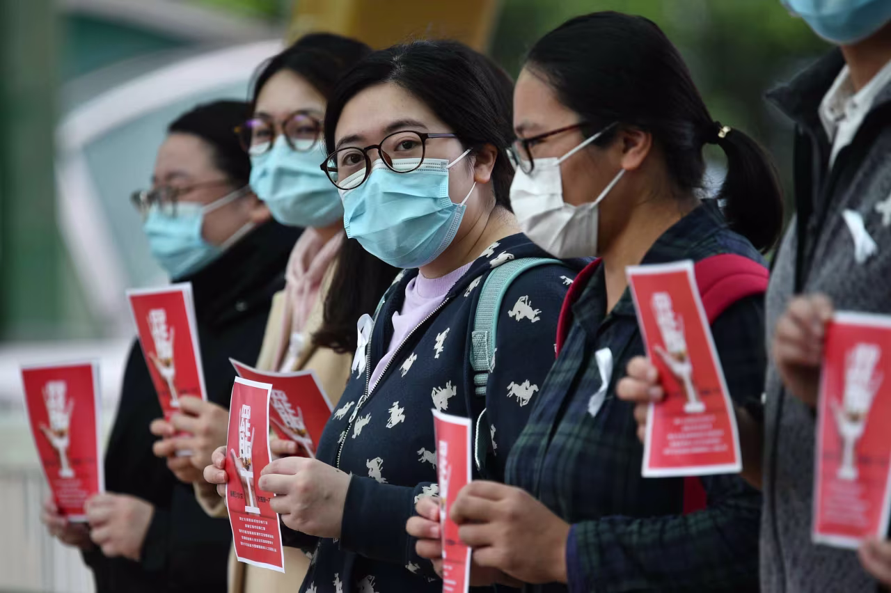 Local medical workers hold a strike near Queen Mary Hospital in Hong Kong on Friday.