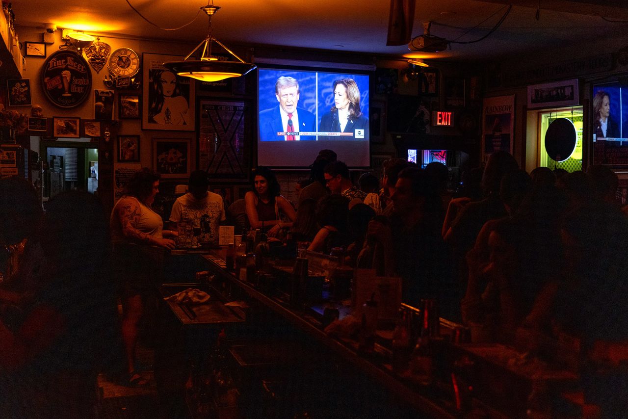 Patrons at the Dew Drop Inn in Washington, DC, watch the debate Tuesday night.