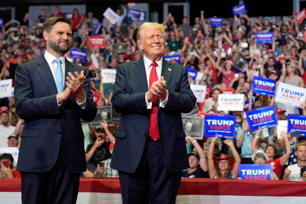 Former President Donald Trump, right, and running mate JD Vance stand onstage at a campaign rally in Grand Rapids, Michigan, on July 20. 