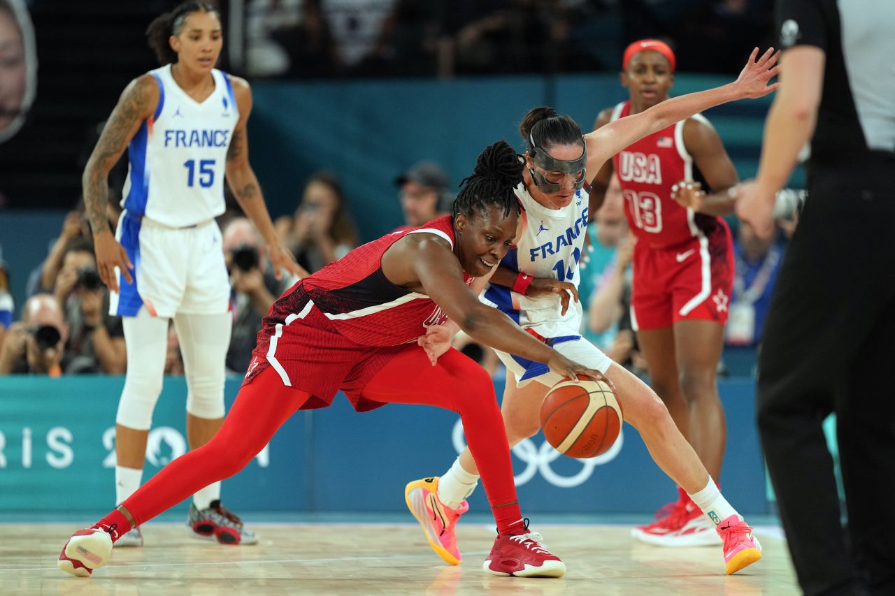 Players fight for control of the ball during the first half of a basketball game between the United States and France on August 11.