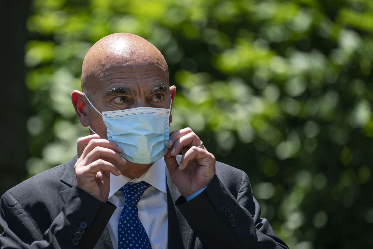 Moncef Slaoui listens as US President Donald Trump delivers remarks about coronavirus vaccine development in the Rose Garden of the White House on May 15 in Washington. 