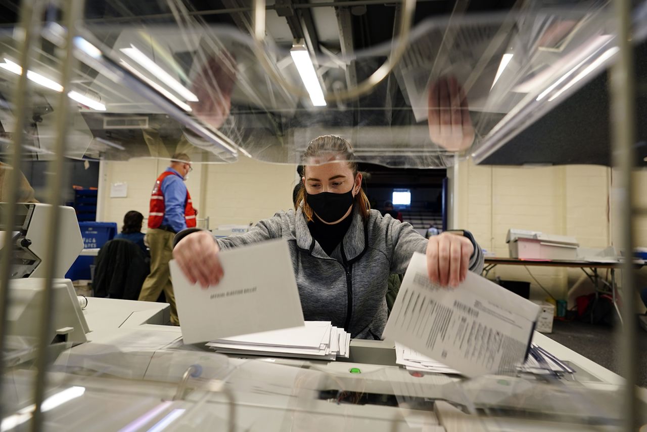 Chester County, Pennsylvania, election worker Kristina Sladek opens mail-in and absentee ballots for the 2020 General Election in the United States at West Chester University on Tuesday, November 3.