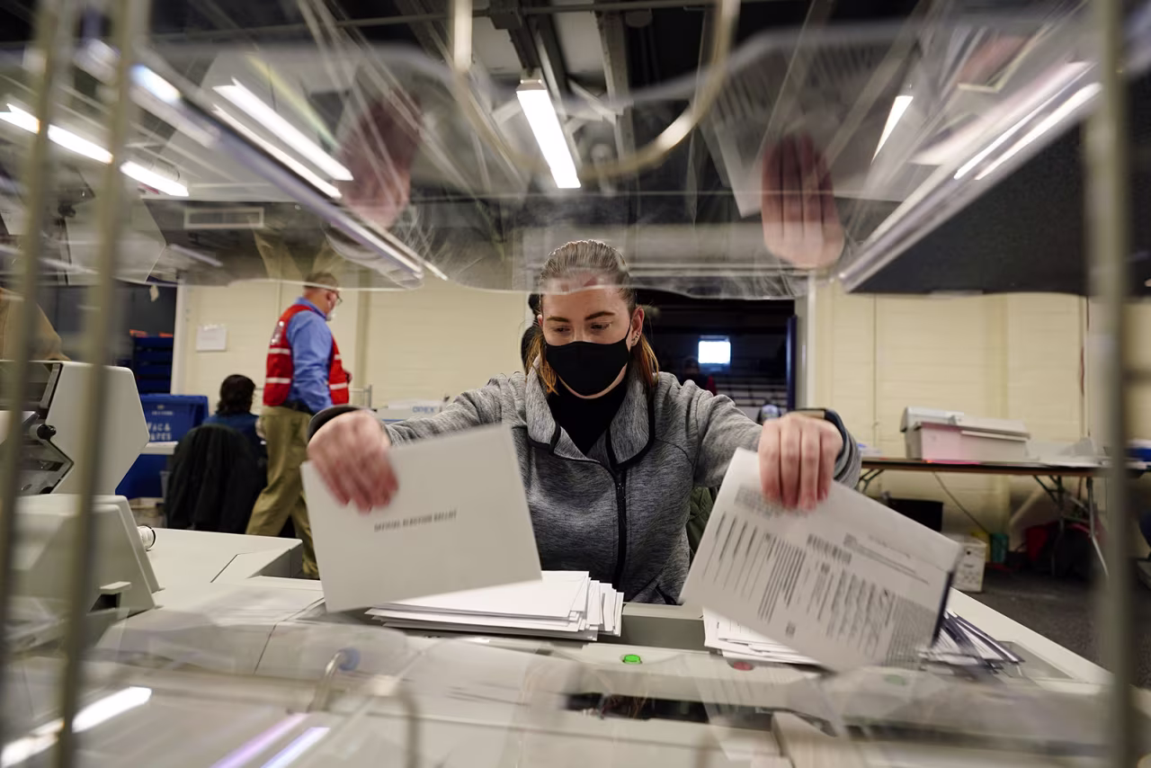 Chester County, Pennsylvania, election worker Kristina Sladek opens mail-in and absentee ballots for the 2020 General Election in the United States at West Chester University on Tuesday, November 3.