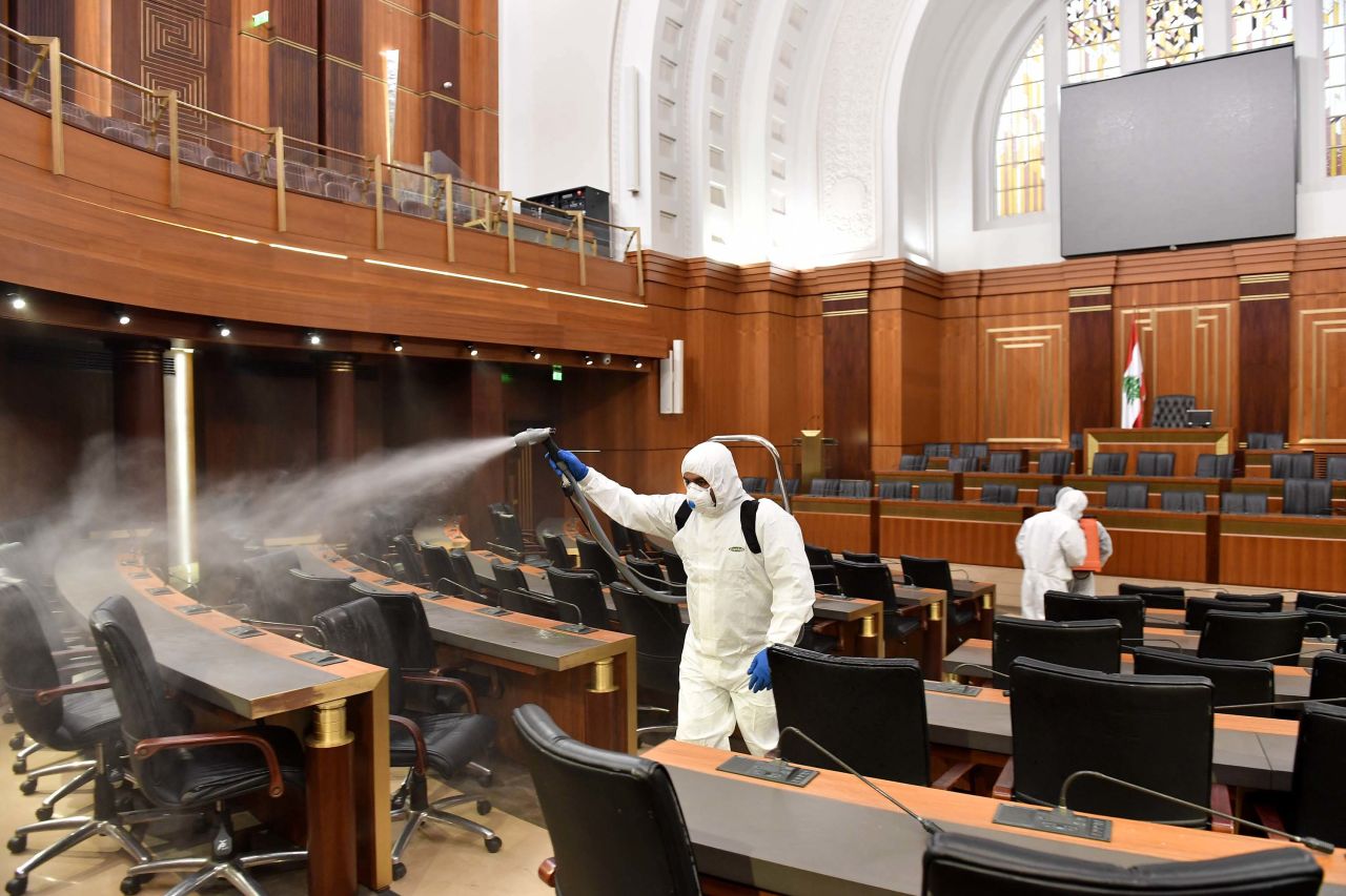 Health officials spray disinfectant at the Lebanese Parliament building in Beirut, Lebanon on Tuesday, as a precaution against the coronavirus.