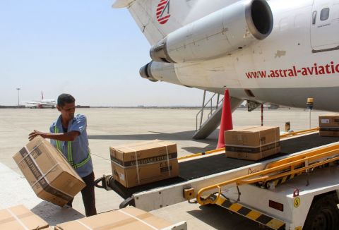 An employee unloads boxes from a plane that carried Yemen's first shipment of Covid-19 vaccines, via the international COVAX facility, at the airport of Yemen's southern port city of Aden on March 31.
