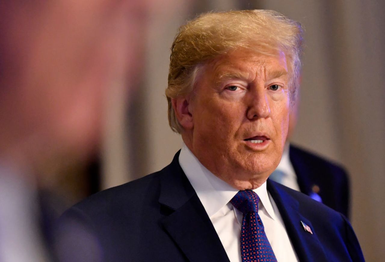 President Donald Trump gestures as he arrives for a working dinner in Brussels on July 11, 2018, during the North Atlantic Treaty Organization (NATO) summit.