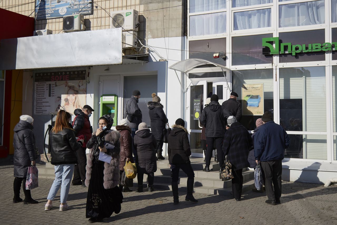 Local residents wait outside a Privatbank on February 15, in Melitopol, Ukraine. 