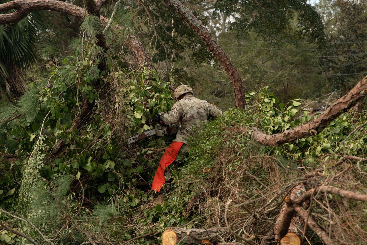 US Army Sgt. 1st Class Stuart Stroubel clears a downed tree in Augusta, Georgia, on September 30.