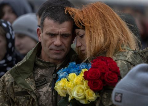 Sergey Zhelisko is hugged as his son, Ukrainian soldier Dmitry Zhelisko, is buried in Rusyn. 