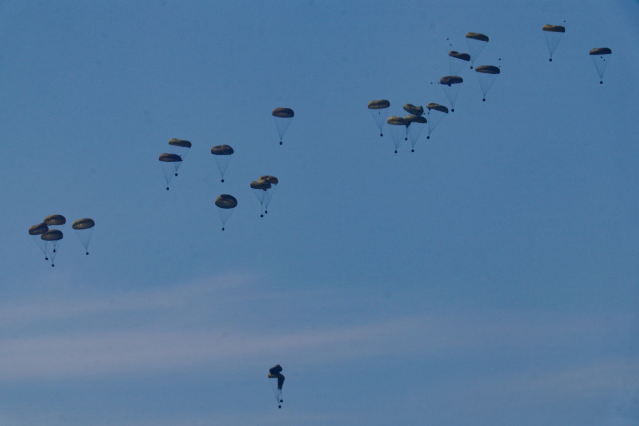 Aid packages fall towards northern Gaza after being dropped from a military aircraft on March 9.