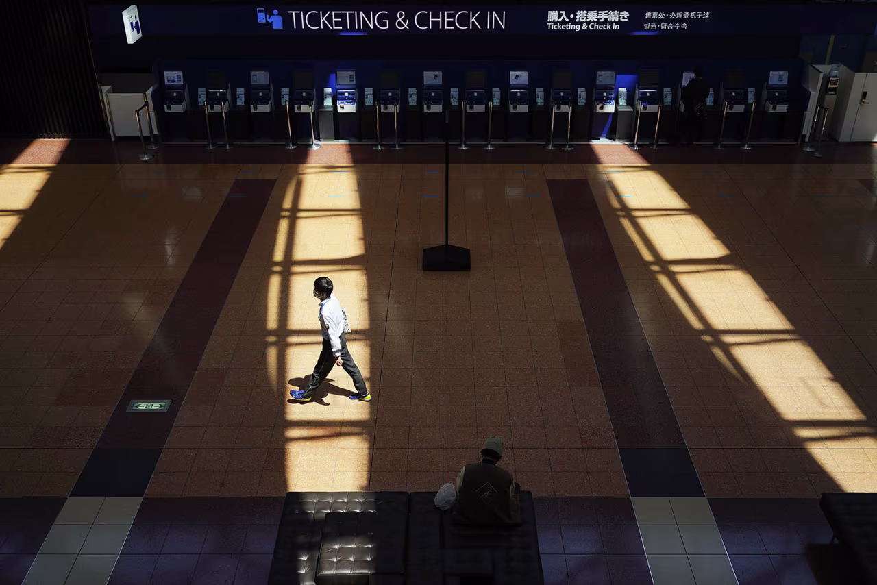 A passenger walks at an empty domestic terminal of Haneda Airport in Tokyo, at the start of Golden Week holiday Wednesday, on April 29.