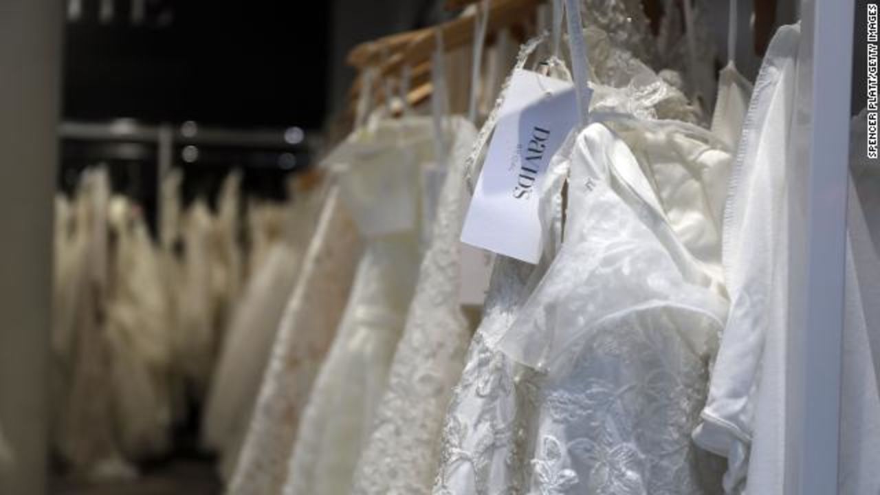 ?Wedding dresses are displayed in a window at a David's Bridal store in Manhattan.