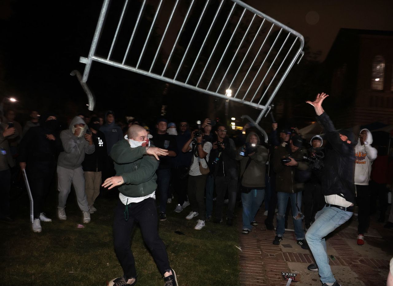Pro-Palestinian protestors and pro-Israeli supporters clash at an encampment at UCLA early Wednesday morning.