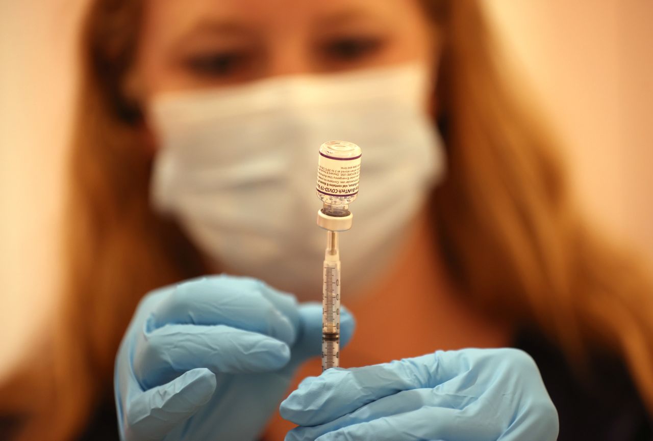 Safeway pharmacist Ashley McGee fills a syringe with the Pfizer COVID-19 booster vaccination at a clinic on October 1, in San Rafael, California. 