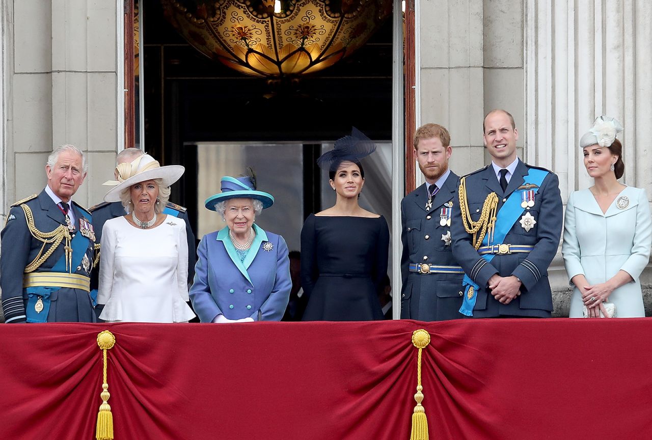 Prince Charles, Prince of Wales, Camilla, Duchess of Cornwall, Queen Elizabeth II, Meghan, Duchess of Sussex, Prince Harry, Duke of Sussex, Prince William, Duke of Cambridge and Catherine, Duchess of Cambridge watch the RAF flypast on the balcony of Buckingham Palace, as members of the Royal Family attend events to mark the centenary of the RAF on July 10, 2018 in London, England. 