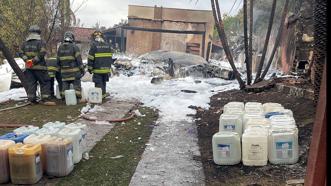 Debris is pictured as emergency personnel work at the site of the crash.