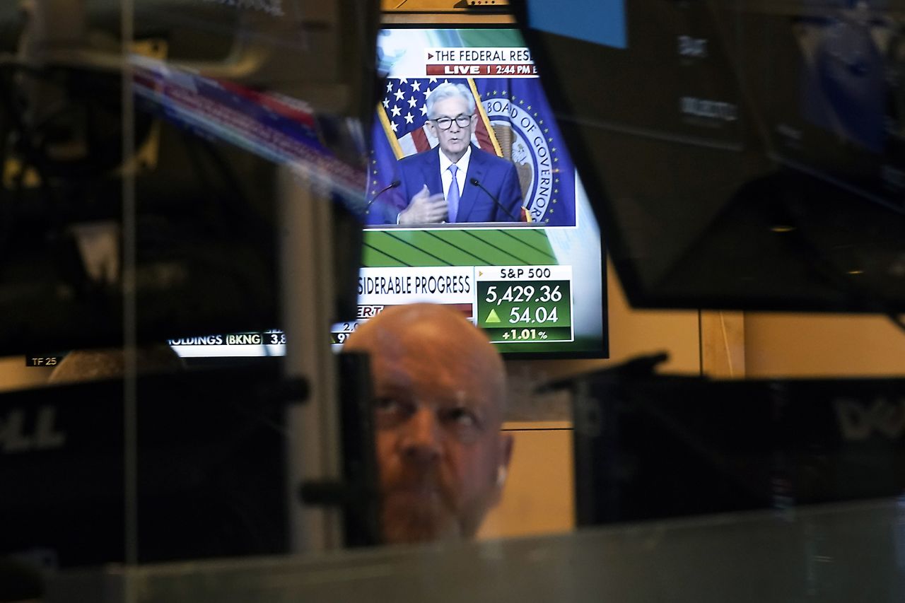 Federal Reserve Chairman Jerome Powell is framed by a trader's screens on the floor of the New York Stock Exchange, on Wednesday, June 12.